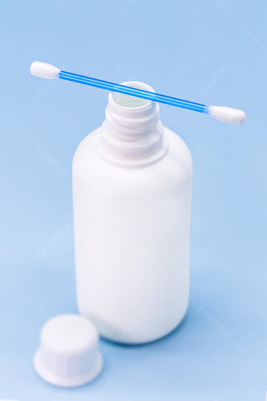 Frasco branco de plástico com cotonete azul em fundo claro