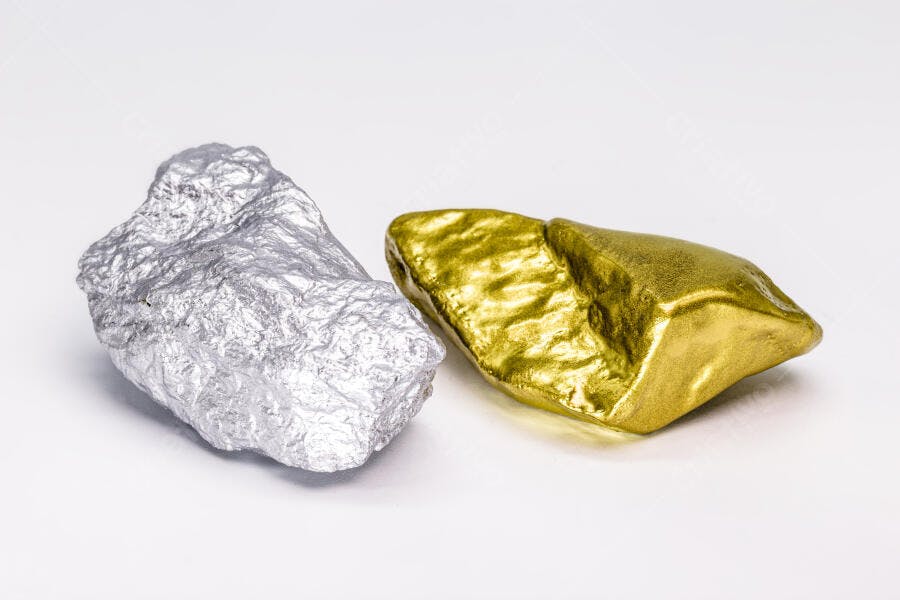 Duas pepitas metálicas ouro e prata em fundo branco