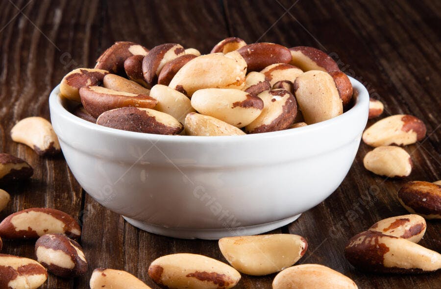 Castanhas-do-Pará em bowl branco sobre madeira escura alimentação saudável