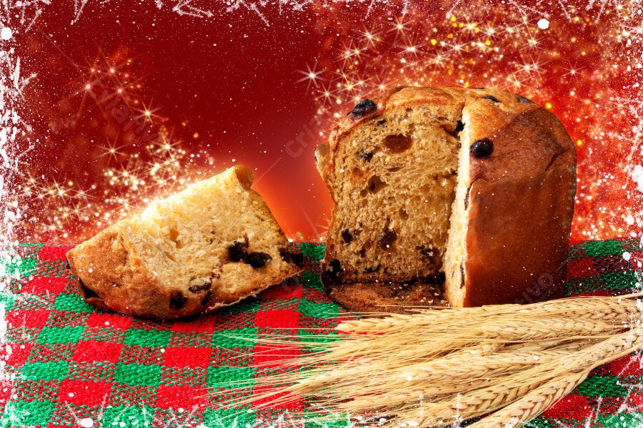 Panettone fatiado com trigo em fundo vermelho natalino e brilhos dourados
