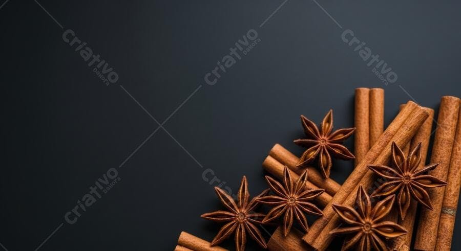 Canela em pau e anis estrelado marrons sobre fundo cinza escuro