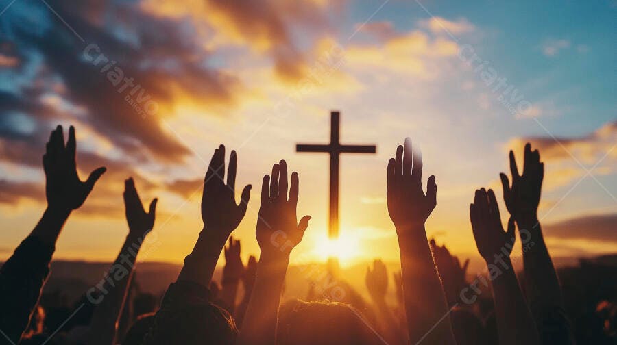 Mãos de fiéis erguidas em adoração à cruz ao pôr do sol dourado