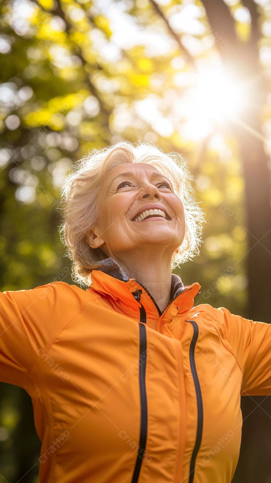 Mulher idosa feliz de jaqueta laranja sorrindo no parque ensolarado