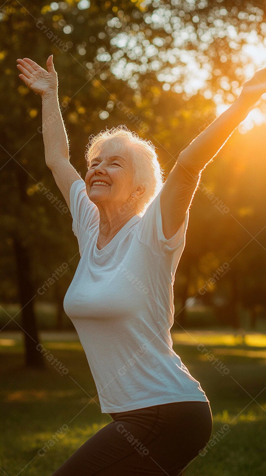 Mulher idosa de cabelo branco sorrindo com braços abertos no parque ao pôr do sol