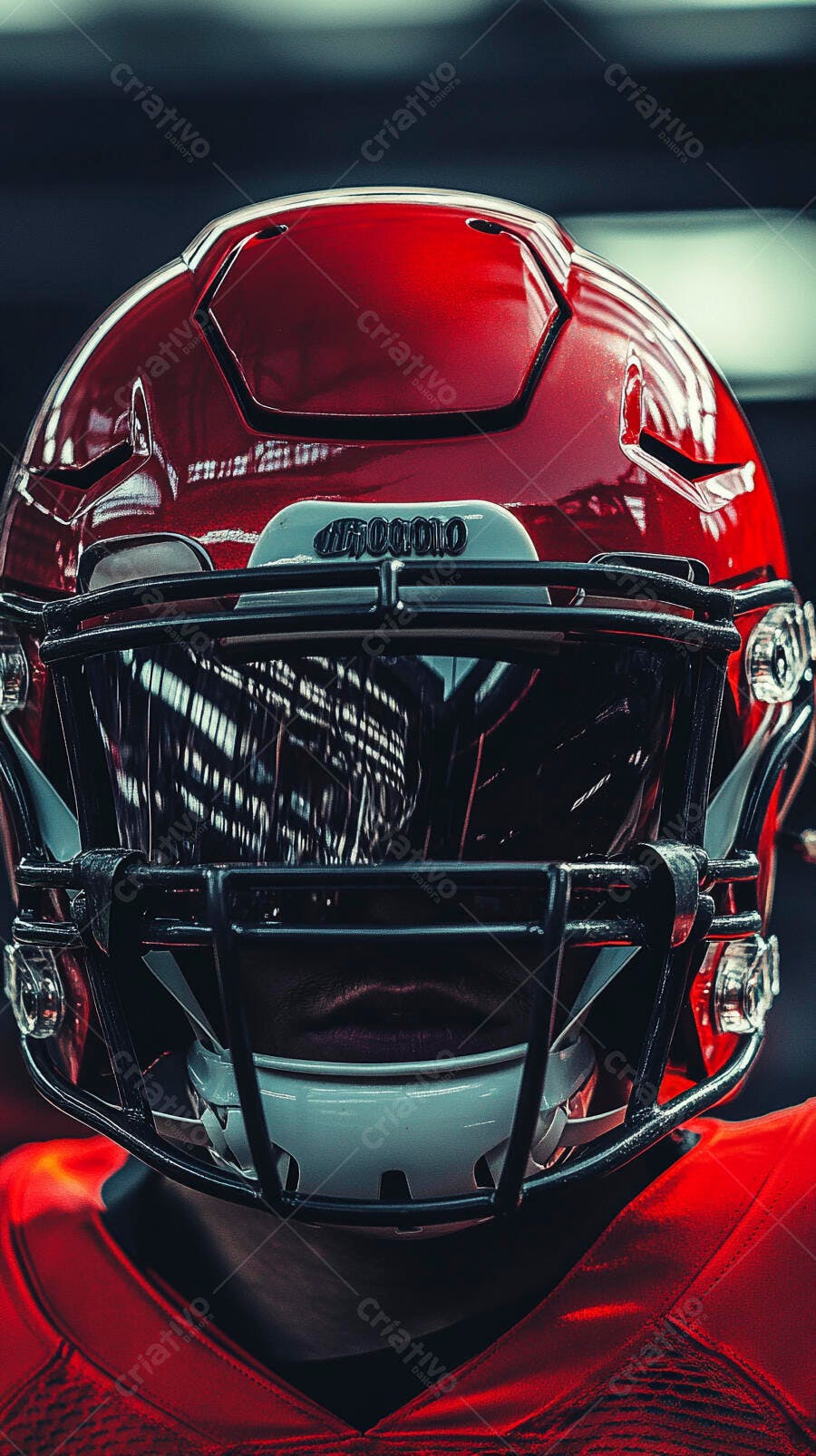 Jogador de futebol americano com capacete vermelho e grade preta