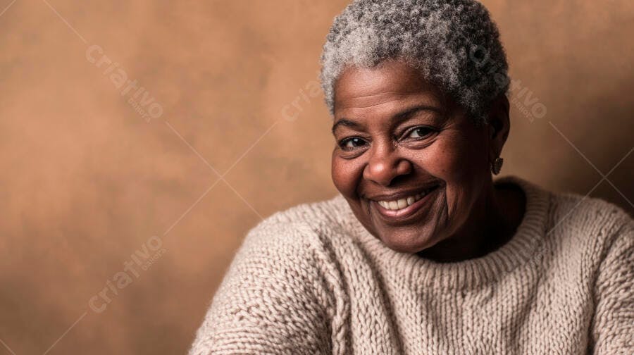 Mulher negra idosa sorrindo feliz com cabelo grisalho e suéter bege