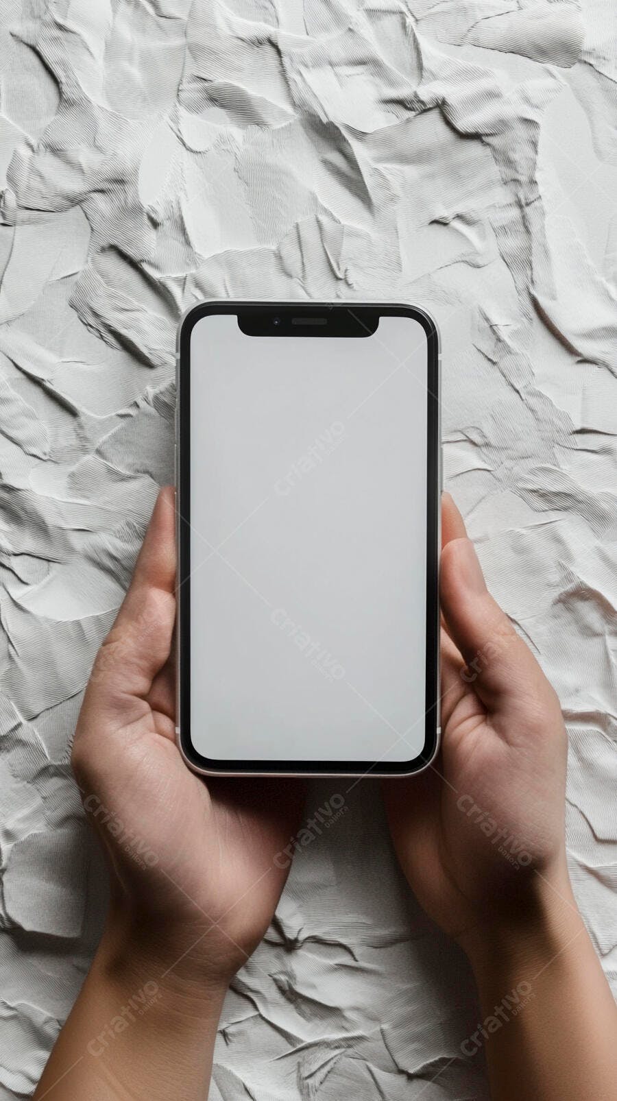 Mãos segurando smartphone com tela branca em fundo texturizado branco e cinza