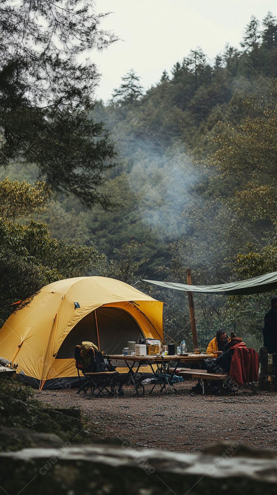 Acampamento na floresta com homens sentados e barraca amarela